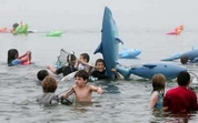 Youngsters take to the water with inflatable sharks as they attend the Jaws Fest 2005 celebrating the release of the 30th anniversary edition DVD of the film 'Jaws' at Martha's Vineyard, Massachusetts June 4, 2005.  Photo by Reuters (Handout)